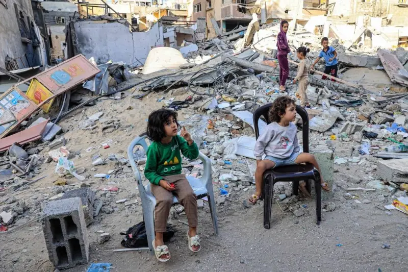 Palestinian children sit in front of the rubble of a destroyed building in Rafah in the southern Gaza Strip on Monday. AFP