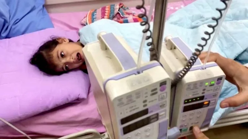 A Palestinian girl cancer patient lies on a bed in the cancer unit at Rantisi hospital, which according to doctors, is running out of supplies, putting dozens of patients at risk, in this still image taken from a video, in Gaza City Tuesday.  REUTERS TV/via REUTERS