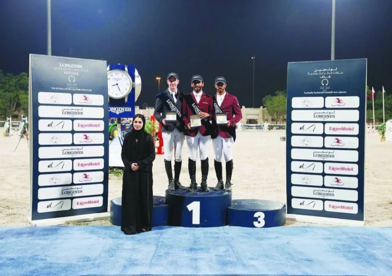 Small Tour winner Mohamed Dhafi al-Marri, runner-up  Lee Carey and third-placed Ghanim Nasser al-Qadi pose with Nouf al-Mansour, Head of Sports Committee, on the podium yesterday.