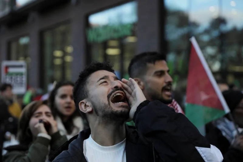 Demonstrators shout slogans during a march in a protest, in solidarity with Palestinians in Gaza, in London, on Saturday. REUTERS