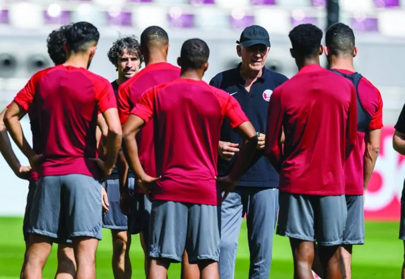 Qatar&#039;s head coach Carlos Queiroz talks to his players during a training session at the Khalifa International Stadium yesterday.
