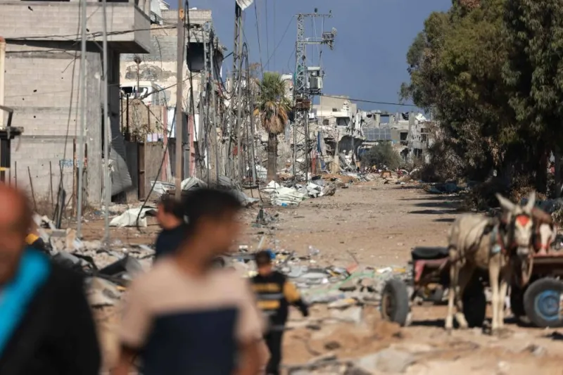 Palestinians walk down a debris-strewn road as they flee Gaza City and other parts of northern Gaza towards the southern areas of the enclave, on Saturday. AFP