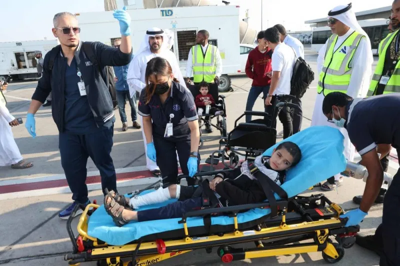 Volunteers transport a wounded Palestinian child off the plane upon their arrival in Abu Dhabi on Saturday, after being evacuated from Gaza as part of a humanitarian mission organised by the United Arab Emirates. AFP
