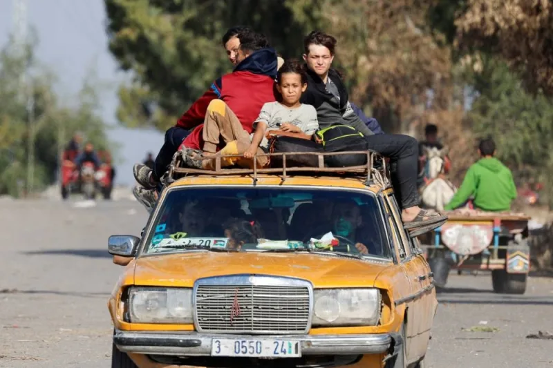 Palestinians fleeing north Gaza ride a car as they move southward in the central Gaza Strip, on Saturday. REUTERS