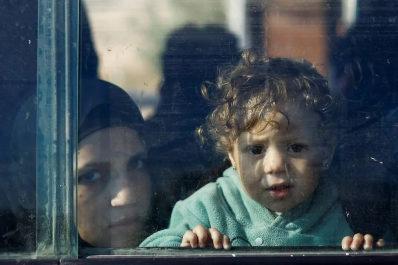A Palestinian child looks out the window of a vehicle while fleeing north Gaza and moving southward, as Israeli tanks roll deeper into the enclave, on Saturday. REUTERS