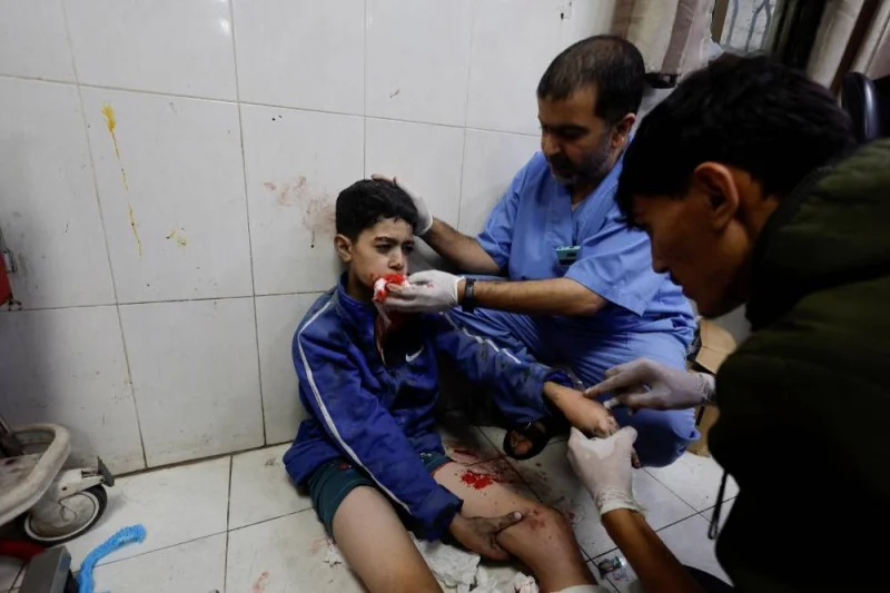 A Palestinian child wounded in an Israeli strike is assisted at Nasser hospital in Khan Younis in the southern Gaza Strip, on Saturday. REUTERS