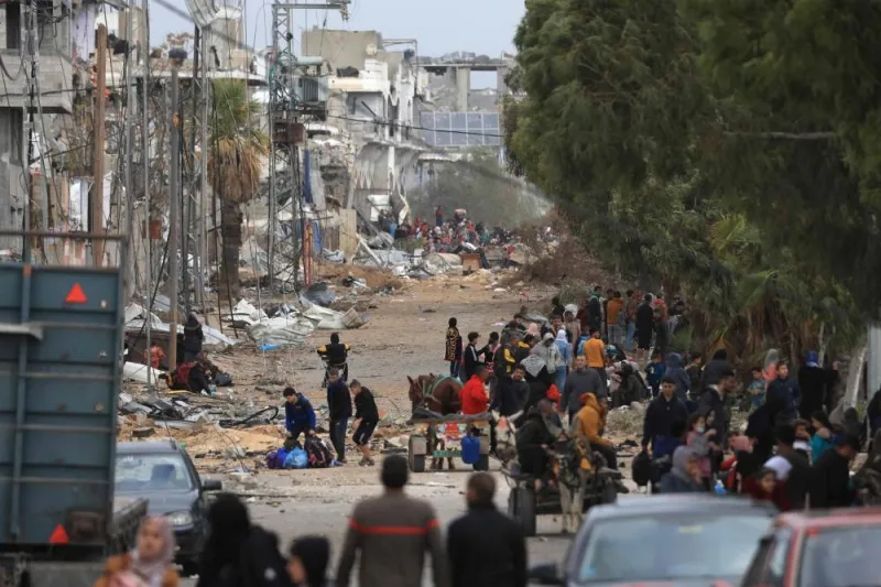 Palestinians fleeing the fighting in war-torn Gaza walk on Salaheddine road in the Zeitoun district of the southern part of the Gaza Strip, on Sunday. AFP
