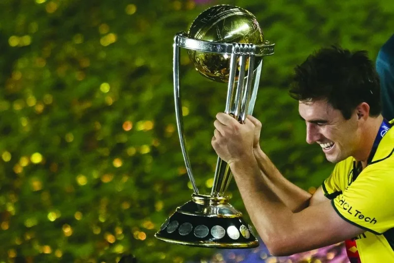 Australia&#039;s captain Pat Cummins celebrates with the trophy after winning the 2023 ICC Cricket World Cup final against India in Ahmedabad Sunday. AFP