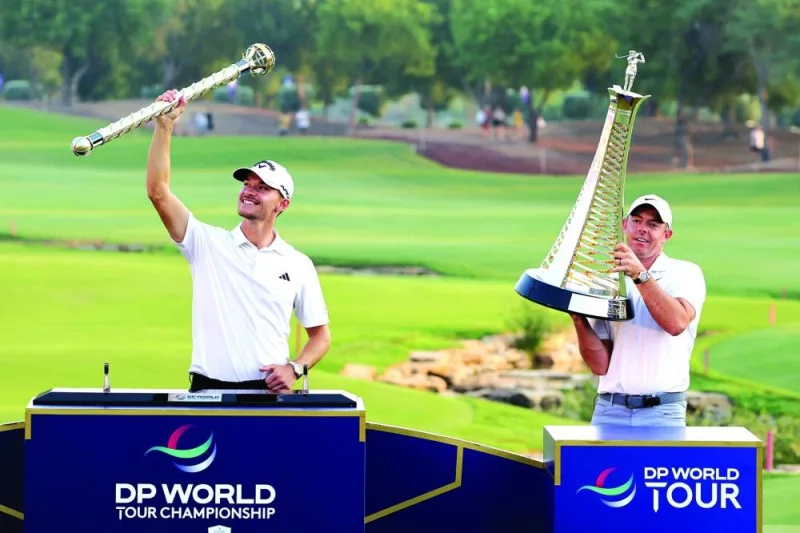 
Denmark’s Nicolai Hojgaard (left) lifts the winner’s trophy as Northern Ireland’s Rory Mcllroy lifts the world championship trophy on the last day of the DP World Tour Championship European Tour golf tournament 2023 at Jumeirah Golf Estates in Dubai yesterday. (AFP) 