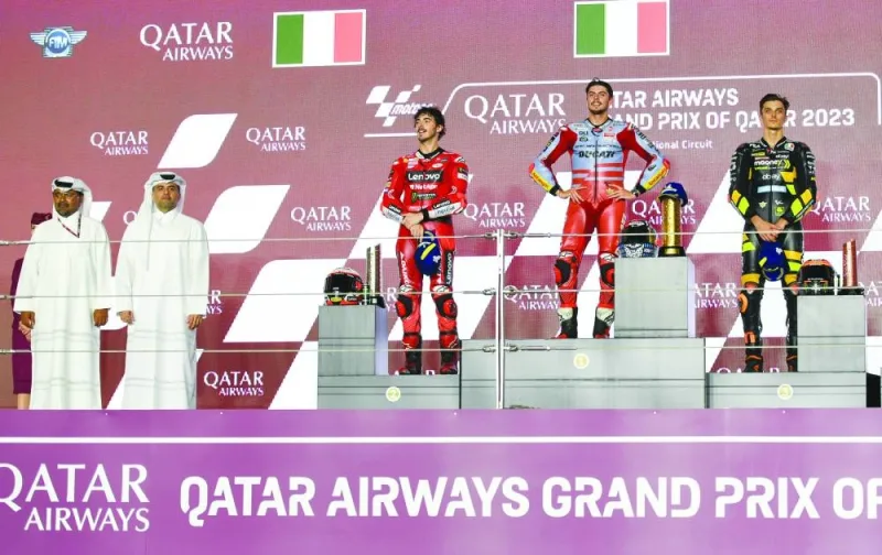 
Qatar Airways Group Chief Executive, Engineer Badr Mohamed al-Meer, and Qatar Motor & Motorcycle Federation and Lusail International Circuit president Abdulrahman bin Abdul Latif al-Mannai pose with the podium finishers of the MotoGP Qatar Grand Prix at the Lusail International Circuit yesterday. PICTURES: Noushad Thekkayil 