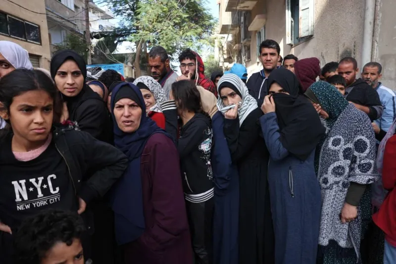 Palestinians queue up to buy bread in Khan Yunis in the southern Gaza Strip, on Tuesday. AFP