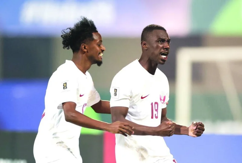 Qatar’s Almoez Ali (right) celebrates with teammate Yousuf Abdurisag after scoring a goal against India in their Group A match of the Preliminary Joint Qualification Round 2 for the FIFA World Cup 2026 and AFC Asian Cup Saudi Arabia 2027 at the Kalinga Stadium in Bhubaneswar yesterday.