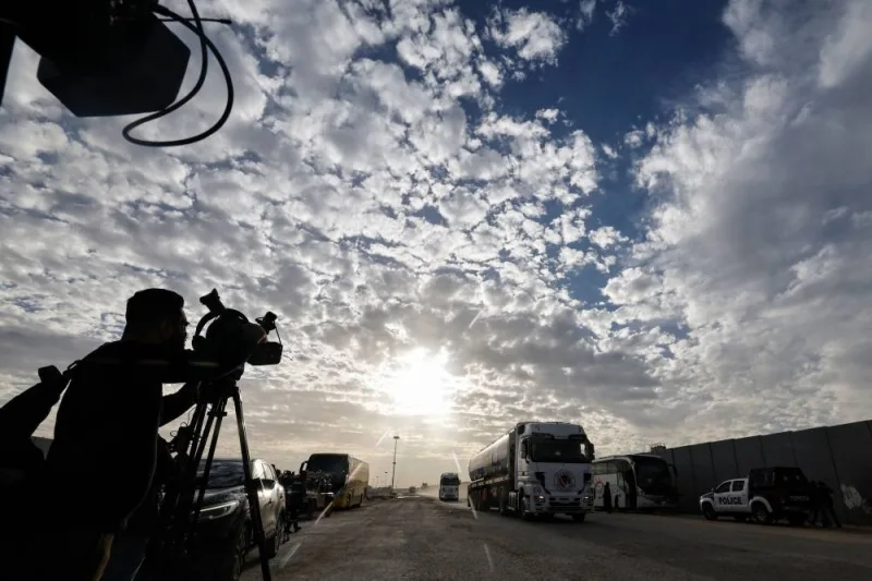 Media representatives work as a truck carrying humanitarian aid from the United Nations Relief and Works Agency for Palestine Refugees (UNRWA) arrives at the Egyptian side of the Rafah border crossing with the Gaza Strip on Wednesday. AFP