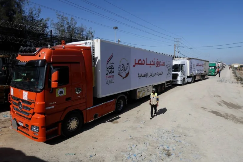 Trucks carrying humanitarian aid enter the Gaza Strip via the Rafah crossing with Egypt, hours after the start of a four-day truce in battles between Israel and Hamas, Friday.