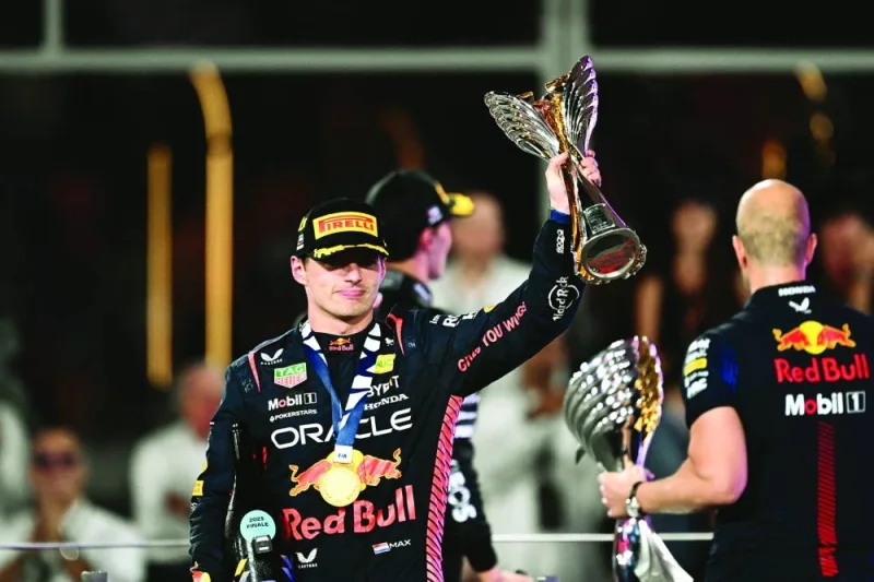 Red Bull Racing&#039;s Dutch driver Max Verstappen celebrates with the trophy on the podium after winning the Abu Dhabi Formula One Grand Prix at the Yas Marina Circuit in the Emirati city yesterday. (AFP)