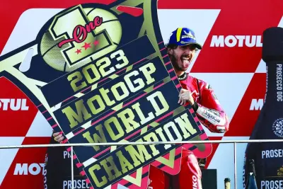 
Ducati Italian rider Francesco Bagnaia celebrates on the podium with the trophy after winning the MotoGP Valencia Grand Prix at the Ricardo Tormo racetrack in Cheste, Valencia, Spain, yesterday. Bagnaia enjoyed a dream day as he retained his MotoGP world title and crowned it with victory in the final race of the season. (AFP) 