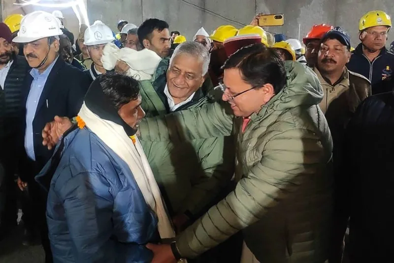 A contruction worker (front L) interacting with India&#039;s Minister of State of Road Transport and Highways VK Singh (C) and Chief minister of Uttarakhand Pushkar Singh Dhami (R) following his rescue from inside the under construction Silkyara tunnel during a rescue operation for trapped workers after a section of the tunnel collapsed in the Uttarkashi district of India&#039;s Uttarakhand state. AFP/  Department of Information and Public Relation, Uttarakhand