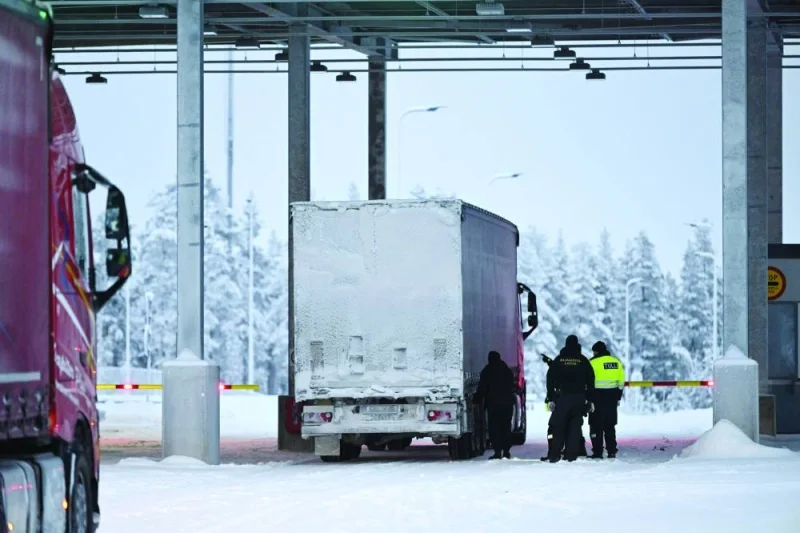 Border guards and a customs official check a truck at the Raja-Jooseppi international border crossing station in Inari, northern Finland, yesterday. (AFP)