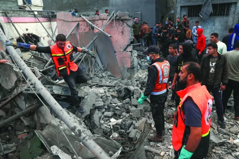 
Palestinian medics search for survivors in the rubble of a building following Israeli bombardment in Rafah in the southern Gaza Strip, yesterday, as fighting resumed shortly after the expiration of the truce. 