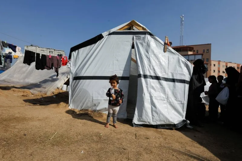 A displaced Palestinian girl stands outside her family tent where they take shelter at Nasser hospital in Khan Younis, in the southern Gaza Strip, on Saturday. REUTERS
