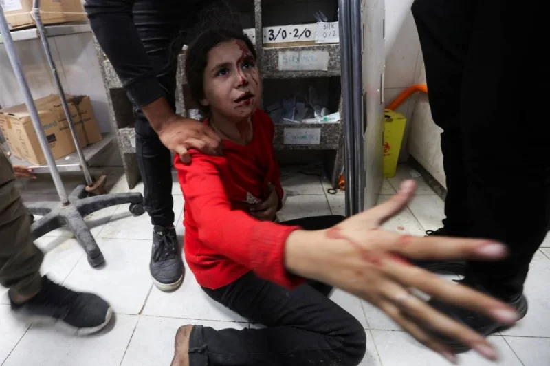 A Palestinian girl sits on the floor after she was rushed to the hospital following an Israeli strike at Nasser hospital in Khan Younis in the southern Gaza Strip, on Sunday. REUTERS