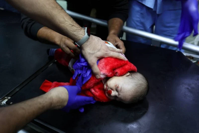 A medical worker assists a wounded Palestinian baby at Nasser hospital, following Israeli strikes, in Khan Younis in the southern Gaza Strip, on Monday. REUTERS