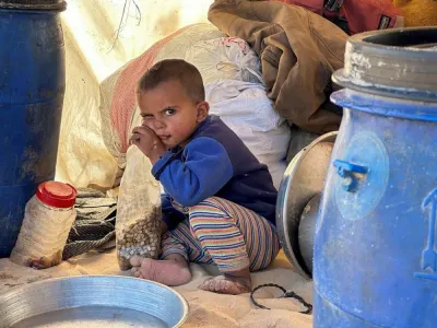 A displaced Palestinian child, who fled his house due to Israeli strikes, sits in a tent near the border with Egypt, in Rafah in the southern Gaza Strip, Wednesday. REUTERS
