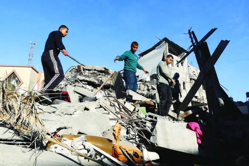 
Palestinians inspect the damage at the site of Israeli strikes on houses, amid the ongoing conflict between Israel and  Hamas, in Khan Yunis in the southern Gaza Strip, yesterday. 