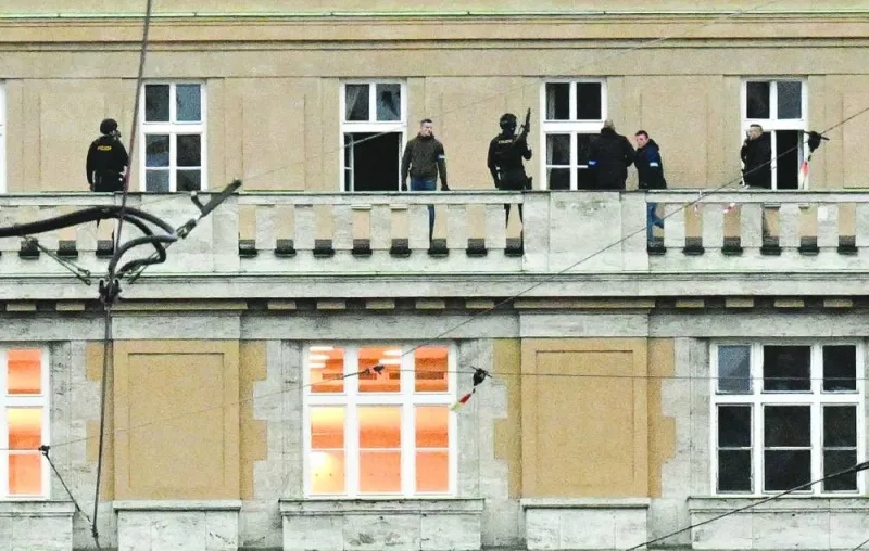 Armed police are seen on the balcony of the Charles University in central Prague on Thursday.