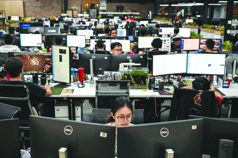 
This photo taken on December 8 shows workers on their computers at the headquarters of Vietnamese Internet firm VNG in Ho Chi Minh City. 
