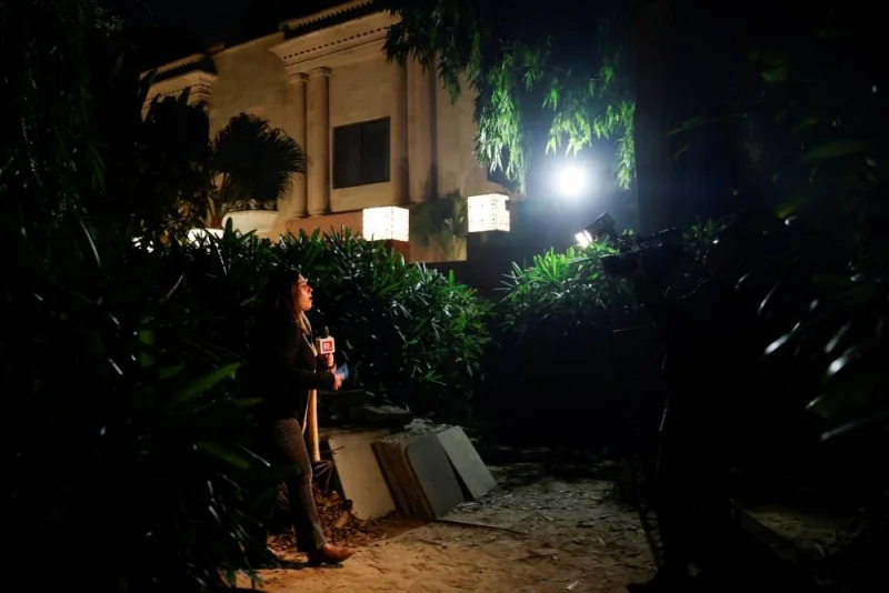 A reporter works outside the Israeli embassy, following a reported explosion nearby, in New Delhi, India, on Tuesday. REUTERS
