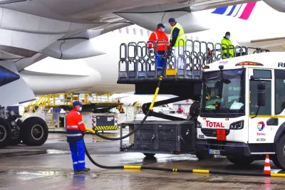Workers connect a Total tanker truck to an Airbus A350 passenger plane, operated by Air France-KLM, during fuelling with sustainable aviation fuel at Charles de Gaulle airport in Roissy, France. SAF production has doubled this year and is expected to further grow and triple in 2024. But the global airline industry represented by the International Air Transport Association says even with that impressive growth, SAF as a portion of all renewable fuel production will only grow from 3% this year to 6% in 2024.