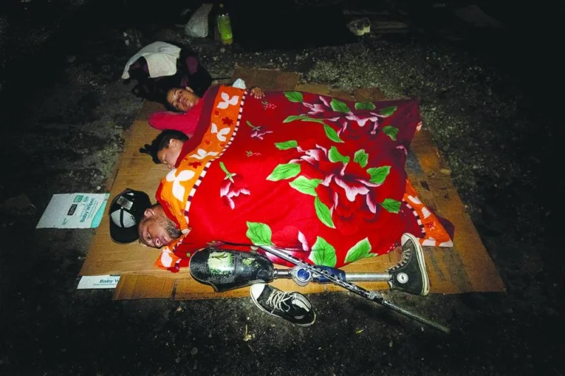 
Maldonado, (front) son Samuel Maldonado (centre) and wife Andrea Loreto (back) sleep at the Paso Canoas shelter in Puntarenas, Costa Rica. (AFP) 
