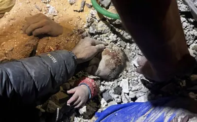 People work to rescue Palestinian girl Mariam Abu Akel, who is alive, from under the rubble of a house hit by an Israeli strike, in Rafah in the southern Gaza Strip, on Friday. REUTERS