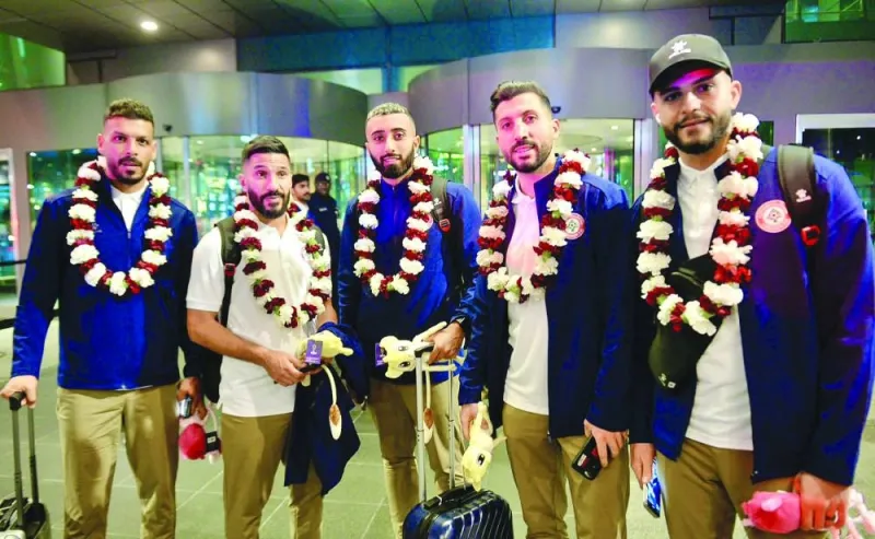 
Lebanon players pose on their arrival at the Hamad International Airport. 