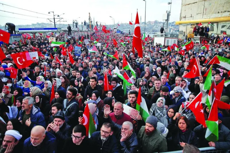 
People gather over the Galata Bridge in solidarity with Palestinians, amid the ongoing conflict, following the first morning prayer of the New Year in Istanbul, Turkiye, yesterday. 