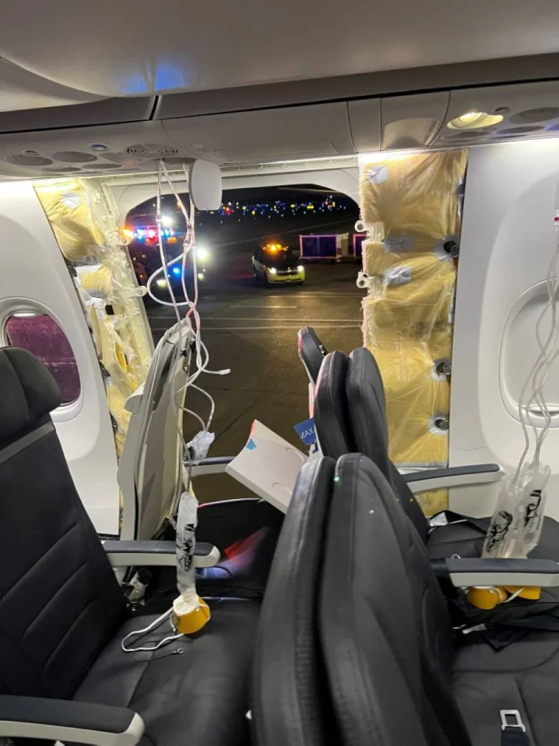 Passenger oxygen masks hang from the roof next to a missing window and a portion of a side wall of an Alaska Airlines Flight 1282, which had been bound for Ontario, California and suffered depressurization soon after departing, in Portland, Oregon, US on Friday. Instagram/@strawberrvy via REUTERS