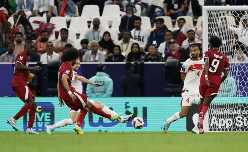 Qatar&#039;s Akram Afif scores their first goal. REUTERS