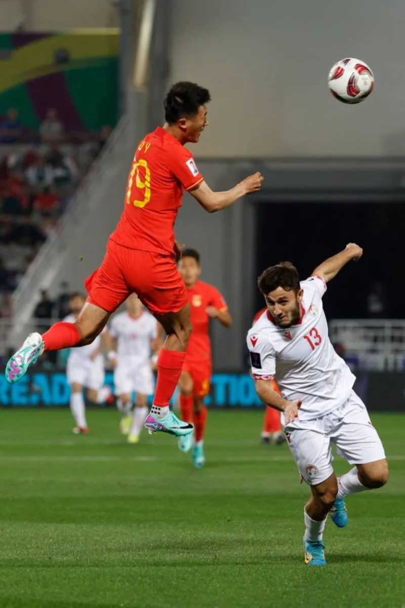 China&#039;s defender 19 Liu Yang and Tajikistan&#039;s midfielder #13 Amadoni Kamolov vie for the ball. AFP
