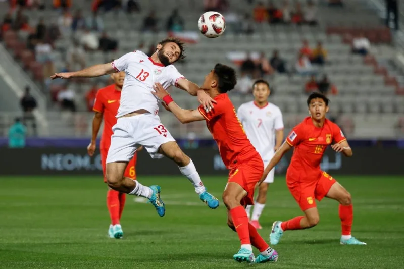 Tajikistan&#039;s midfielder Amadoni Kamolov vies for a header. AFP