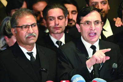 Pakistan Tehreek-e-Insaf party chairman Gohar Khan (right) standing next to Barrister Ali Zafar and other legal team members speak to the media outside the Supreme Court building after the verdict in Islamabad last night. (AFP)