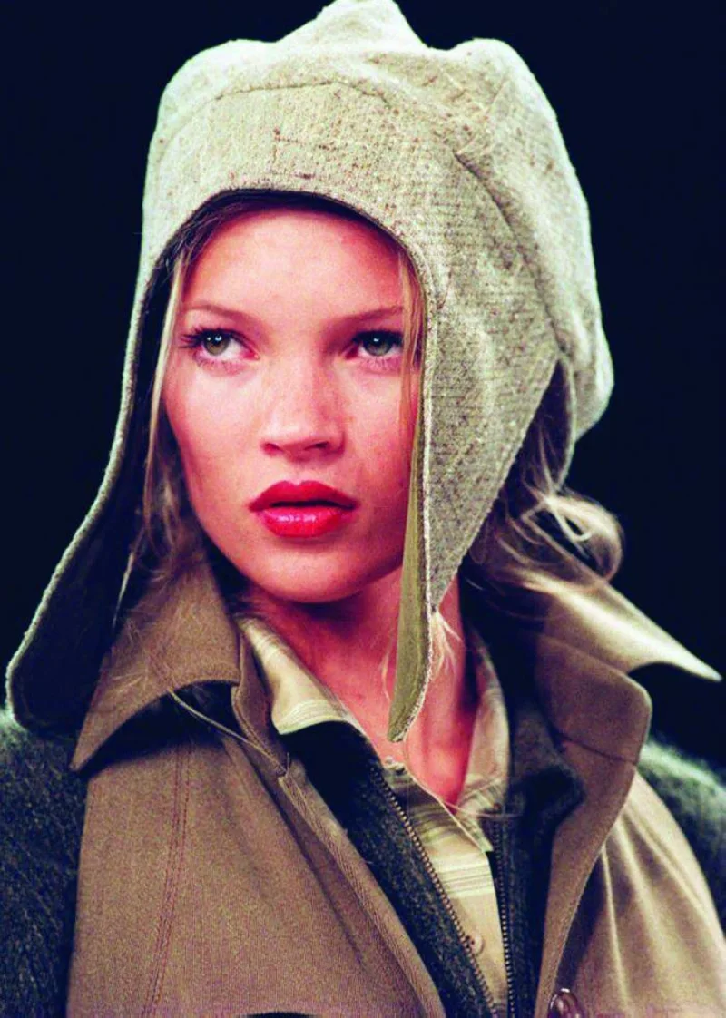 This 1994 file picture shows Kate Moss wearing a flapped hat with a suede jacket during the showing of the Fall 1994 Anne Klein collection.