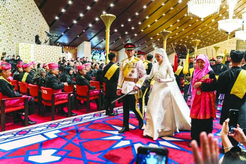 Prince Abdul Mateen and Anisha Rosnah walk down the aisle during their wedding reception at Istana Nurul Iman in Brunei&#039;s capital Bandar Seri Begawan.