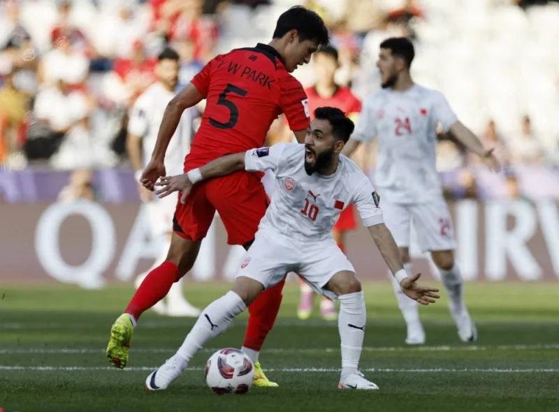 Bahrain&#039;s Kamil Al Aswad in action with South Korea&#039;s Park Yong-woo. REUTERS