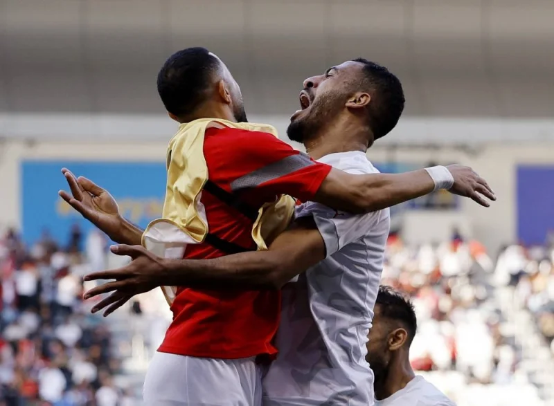 Bahrain&#039;s Abdullah Al Hashash celebrates scoring their first goal with teammates. REUTERS