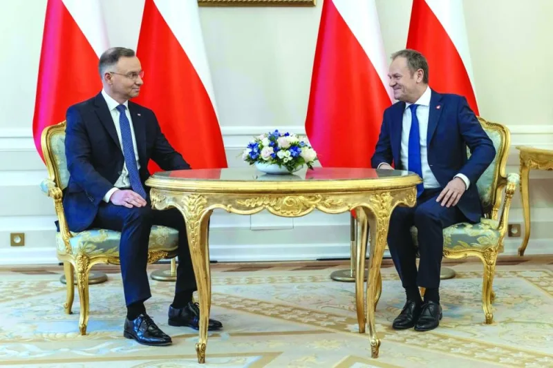 
Polish President Andrzej Duda (left) and Polish Prime Minister Donald Tusk have taken seat for talks during their meeting at the Presidential Palace in Warsaw yesterday. (AFP) 