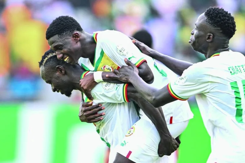 Senegal’s midfielder Lamine Camara (centre) celebrates with teammates after scoring his team’s third goal during the Africa Cup of Nations 2024 Group C match against Gambia in Yamoussoukro on Monday. (AFP)