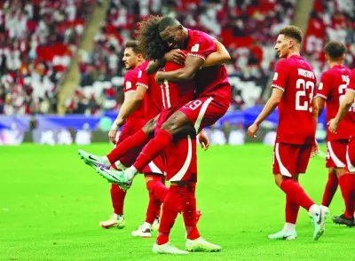 Qatar’s Akram Afif (also right) celebrates with Almoez Ali after scoring a goal against Tajikistan in their Asian Cup match at the Al Bayt Stadium on Wednesday. (Reuters)