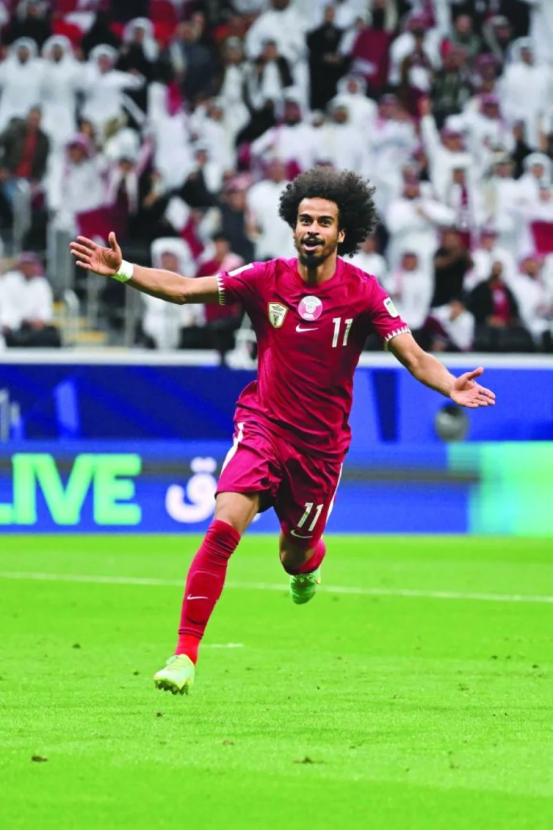 Qatar&#039;s forward  Akram Afif celebrates after scoring goal against Tajikistan at the Al Bayt Stadium on Wednesday. (AFP)
