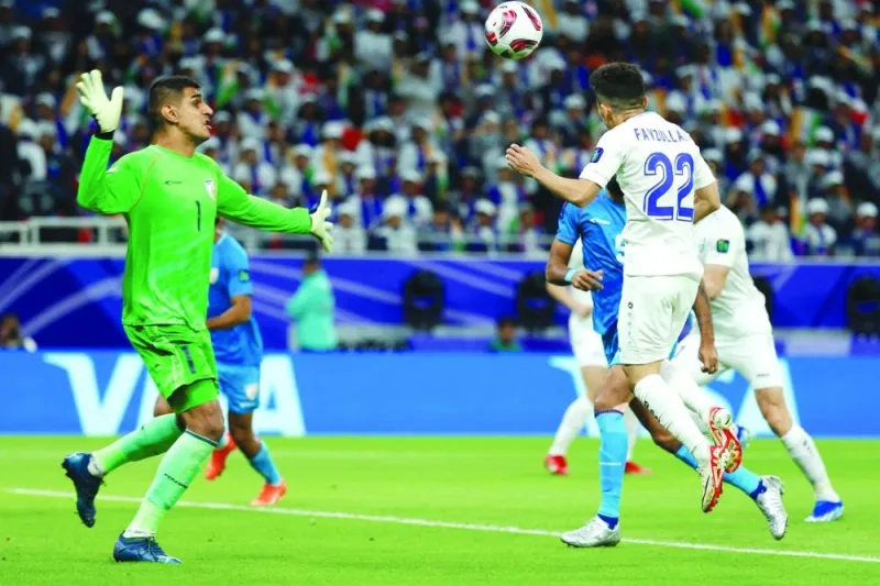 Uzbekistan’s midfielder Abbosbek Fayzullaev scores past India’s goalkeeper Gurpreet Singh Sandhu during the AFC Asian Cup 
Group B match at the Ahmad Bin Ali Stadium in Al Rayyan on Thursday. (AFP)